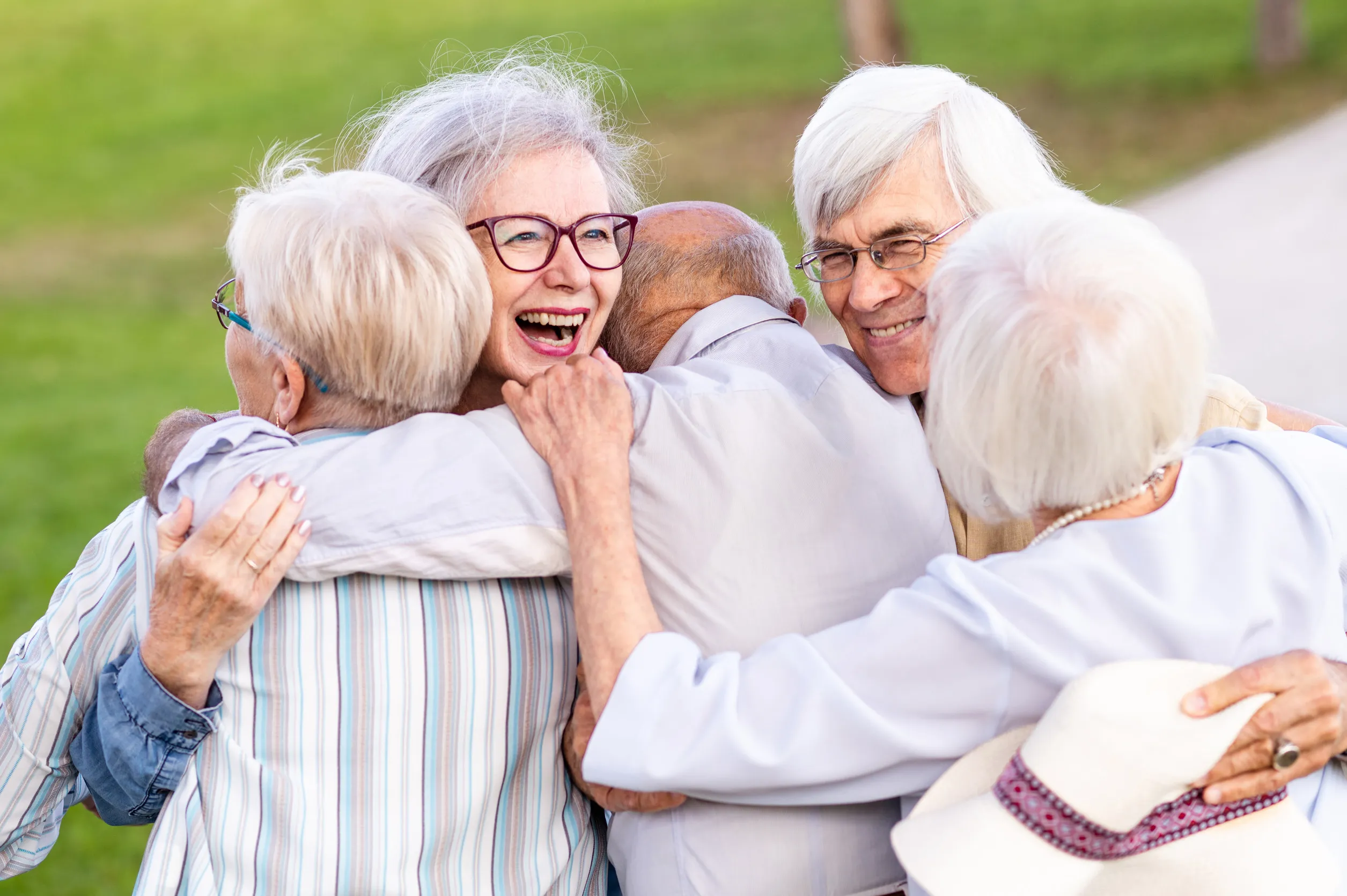 Group of happy elderly people spending time together at outdoors at the park
